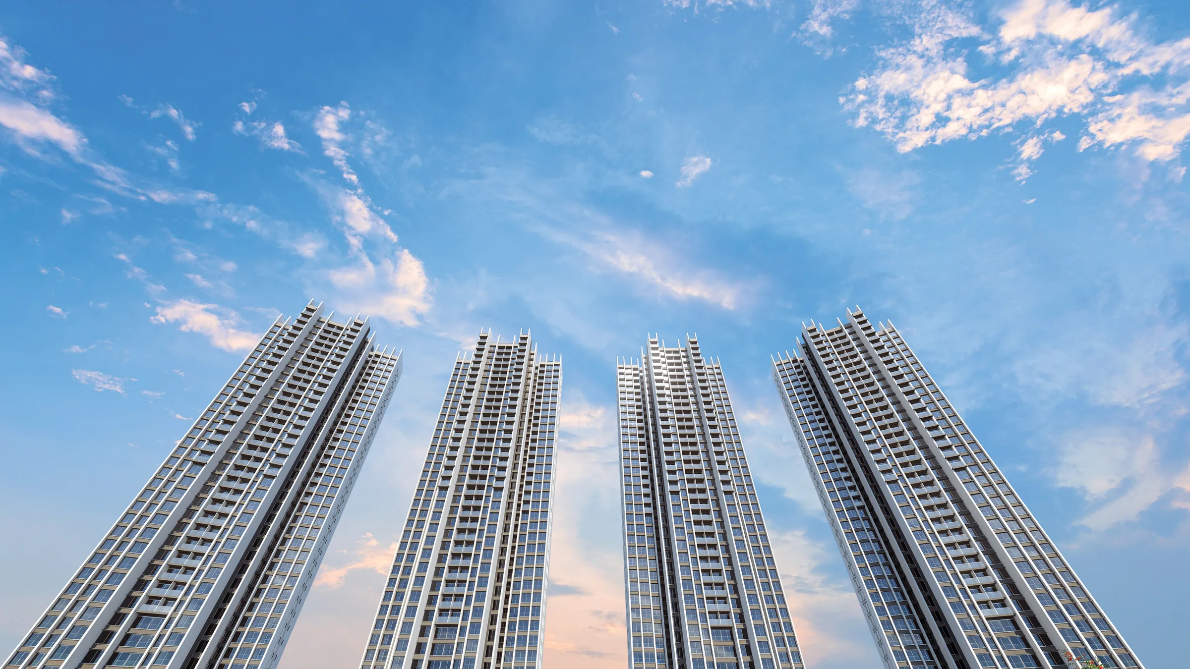 Artist's impression of the Sunteck Belvedere Park towers rising above landscaped grounds beside the green horizon
